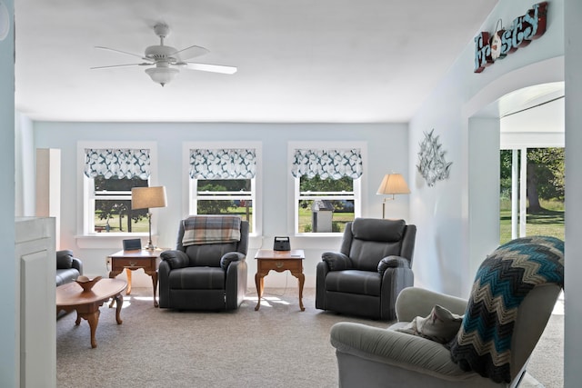 carpeted living room featuring ceiling fan