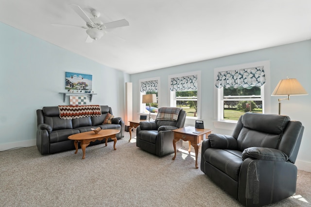 carpeted living room with lofted ceiling and ceiling fan