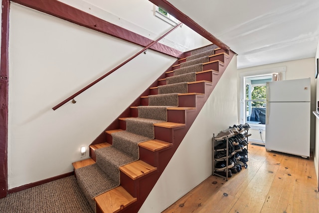 stairway featuring wood-type flooring