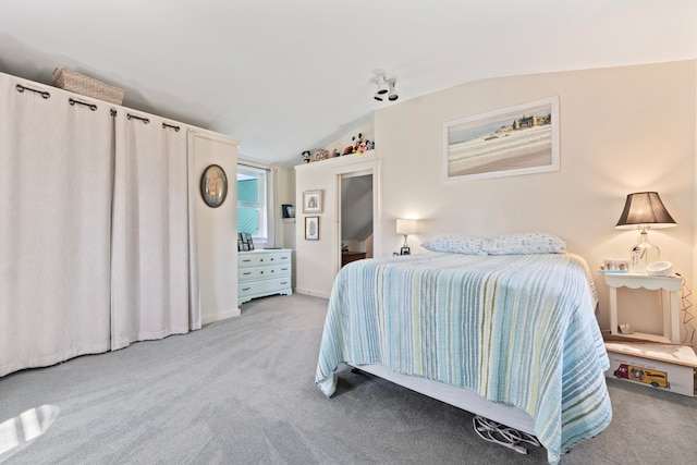 bedroom featuring light carpet and lofted ceiling