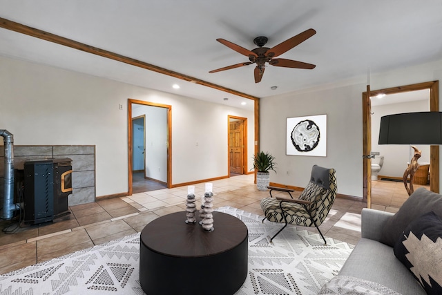 tiled living room with ceiling fan and a wood stove