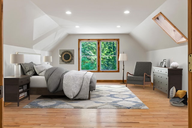 bedroom featuring light hardwood / wood-style floors and lofted ceiling