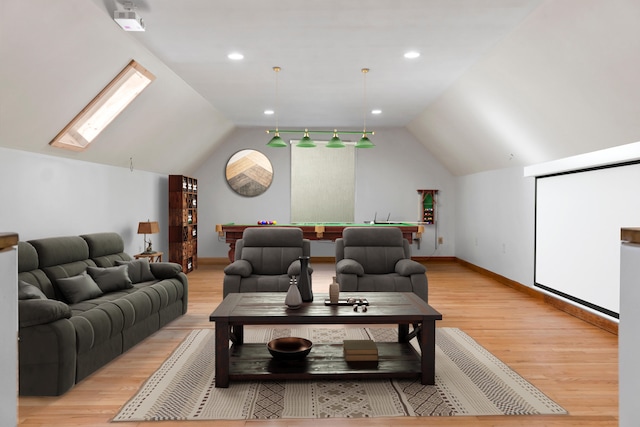 cinema room with pool table, vaulted ceiling with skylight, and light wood-type flooring