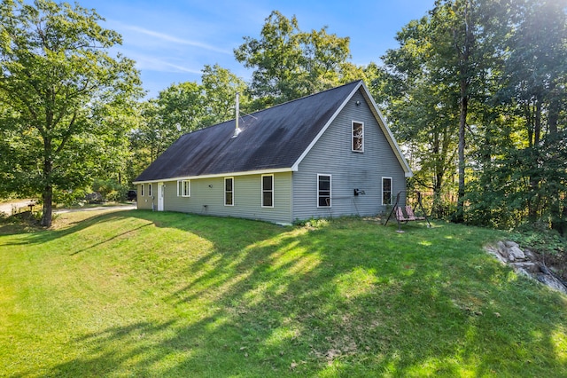 view of property exterior with a yard