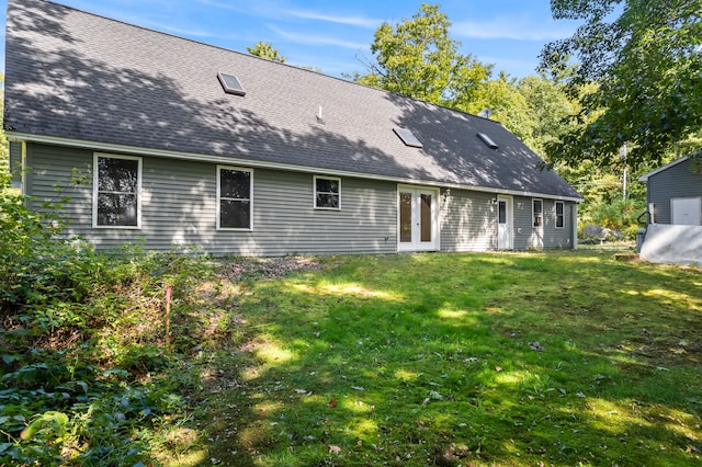 rear view of property with a yard