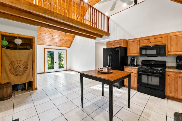 kitchen featuring high vaulted ceiling, light tile patterned floors, black appliances, ceiling fan, and french doors