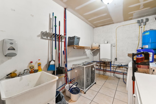 laundry area featuring light tile patterned floors and sink