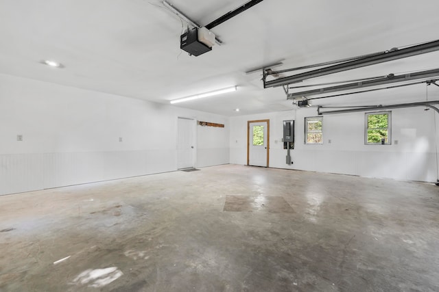 garage with electric panel and a garage door opener