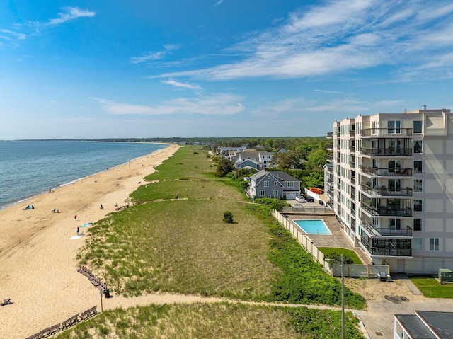 birds eye view of property featuring a water view and a beach view