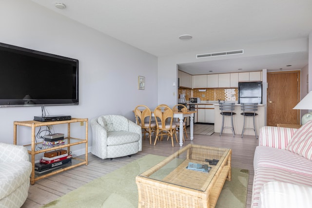 living room with light hardwood / wood-style flooring