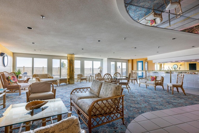 living room with a textured ceiling, plenty of natural light, and carpet flooring