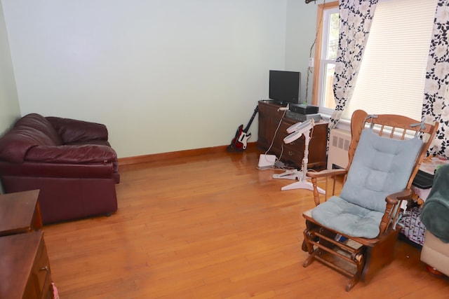 sitting room featuring light hardwood / wood-style flooring and radiator heating unit