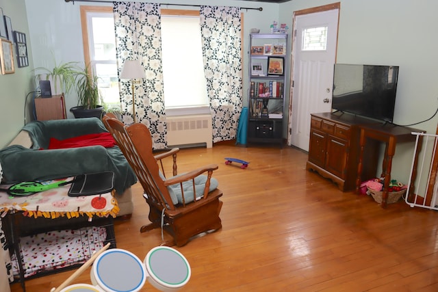 living room with radiator heating unit and wood-type flooring