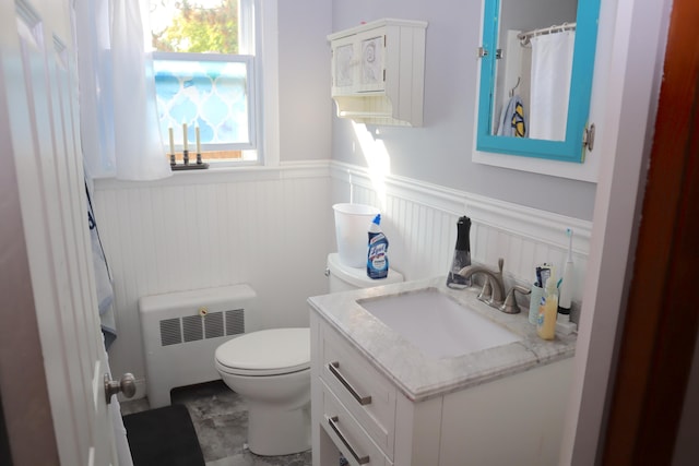 bathroom featuring radiator, toilet, and vanity