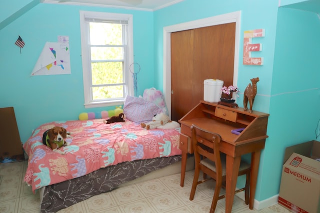 bedroom featuring crown molding and a closet