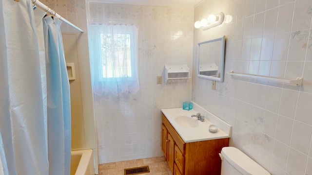 full bathroom featuring tile walls, shower / tub combo, vanity, ornamental molding, and toilet