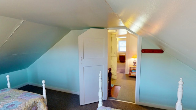 carpeted bedroom featuring lofted ceiling