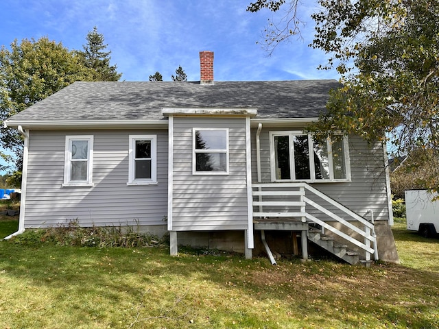 rear view of house with a yard