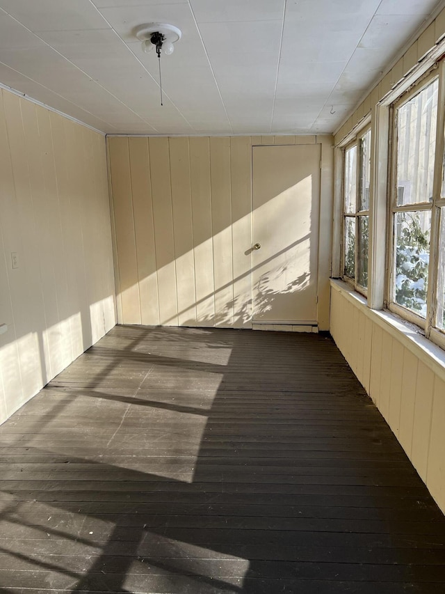 unfurnished sunroom featuring baseboard heating