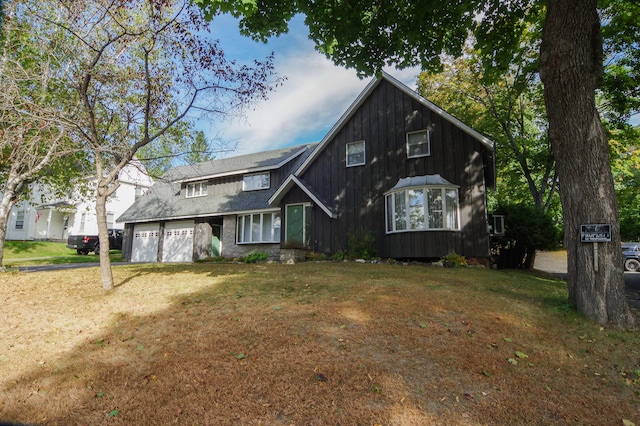 exterior space featuring a front lawn and a garage