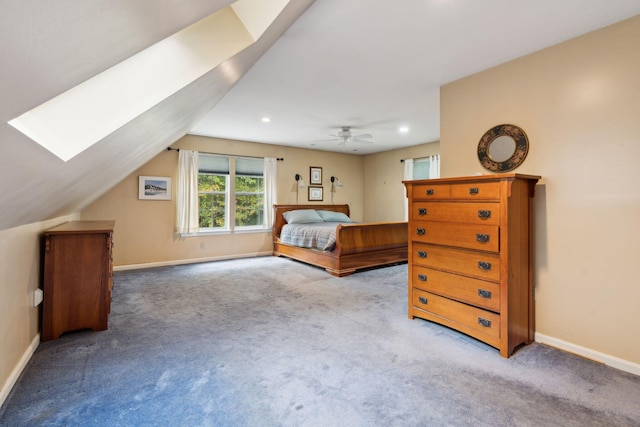 bedroom with lofted ceiling with skylight, ceiling fan, and light carpet