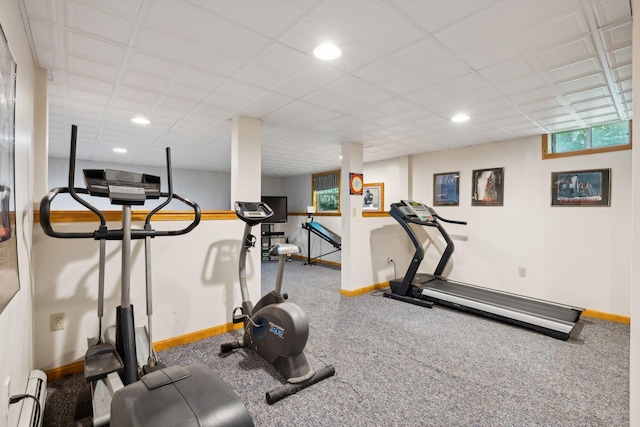 workout room featuring a baseboard heating unit and a paneled ceiling