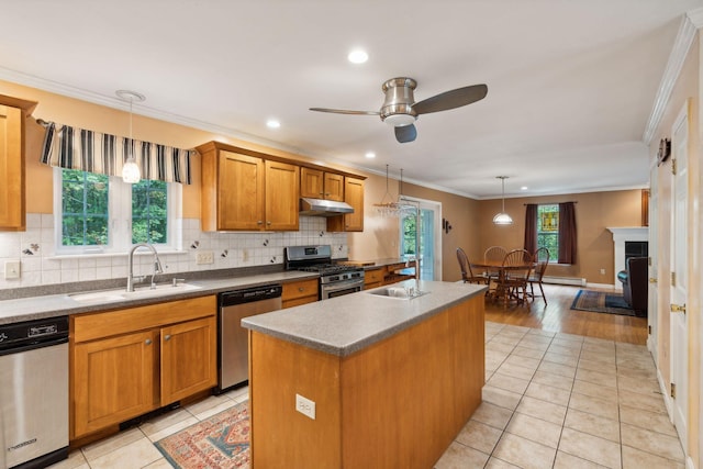 kitchen with ceiling fan, a wealth of natural light, stainless steel appliances, and a center island