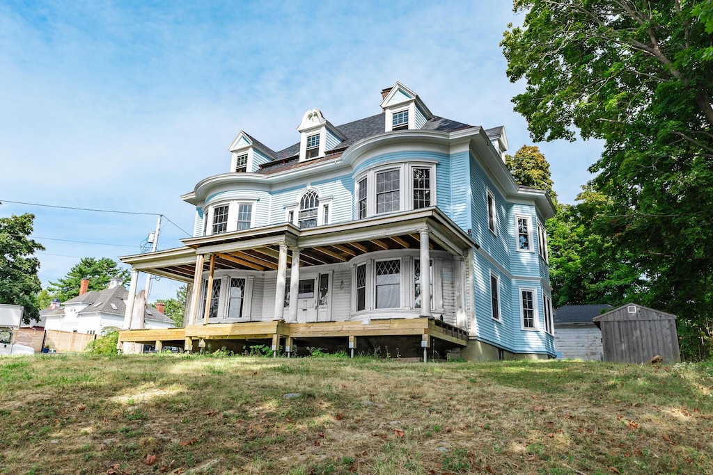 478 State St, Bangor, ME 04401 - view of front of house with a porch, an outdoor structure, and a storage unit