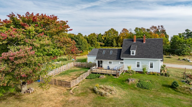 rear view of property with a yard and a wooden deck