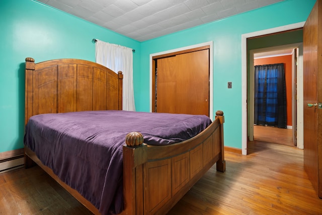 bedroom with light hardwood / wood-style floors and a closet