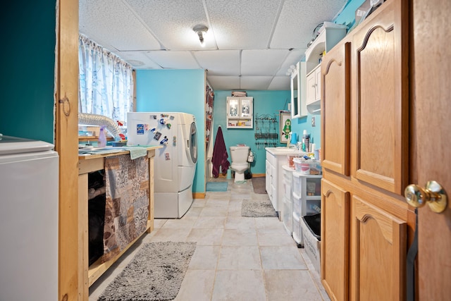 clothes washing area with light tile patterned floors and sink