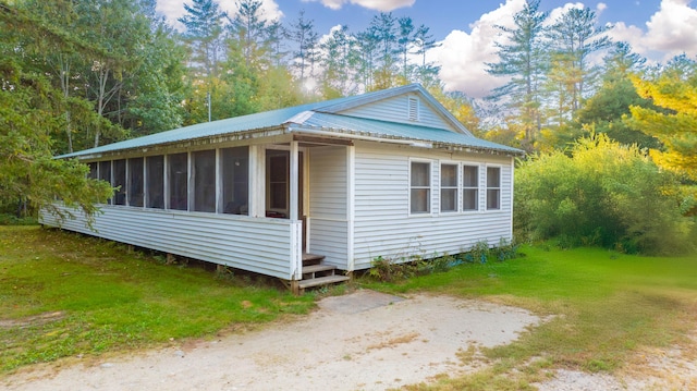 view of side of home featuring a sunroom