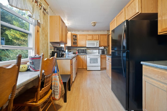 kitchen with light wood-type flooring, white appliances, and light brown cabinetry