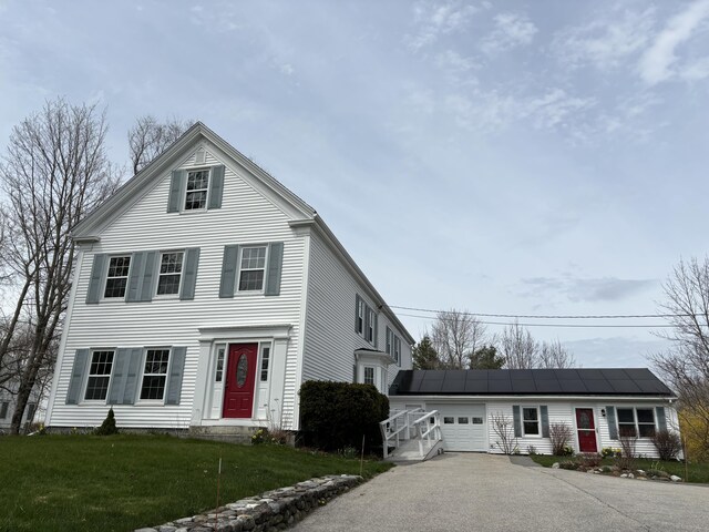 view of front of home featuring an outbuilding, a garage, and a front yard