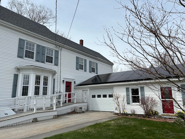 view of front of property with a garage and a front yard