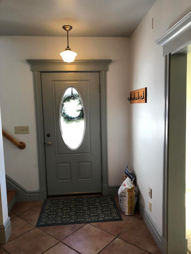 foyer with dark tile patterned flooring