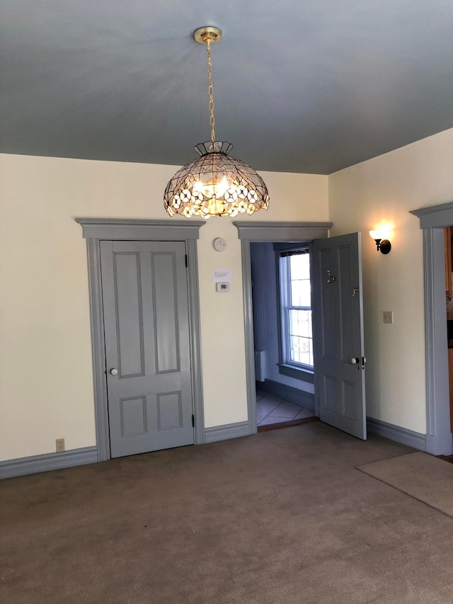 view of carpeted foyer entrance