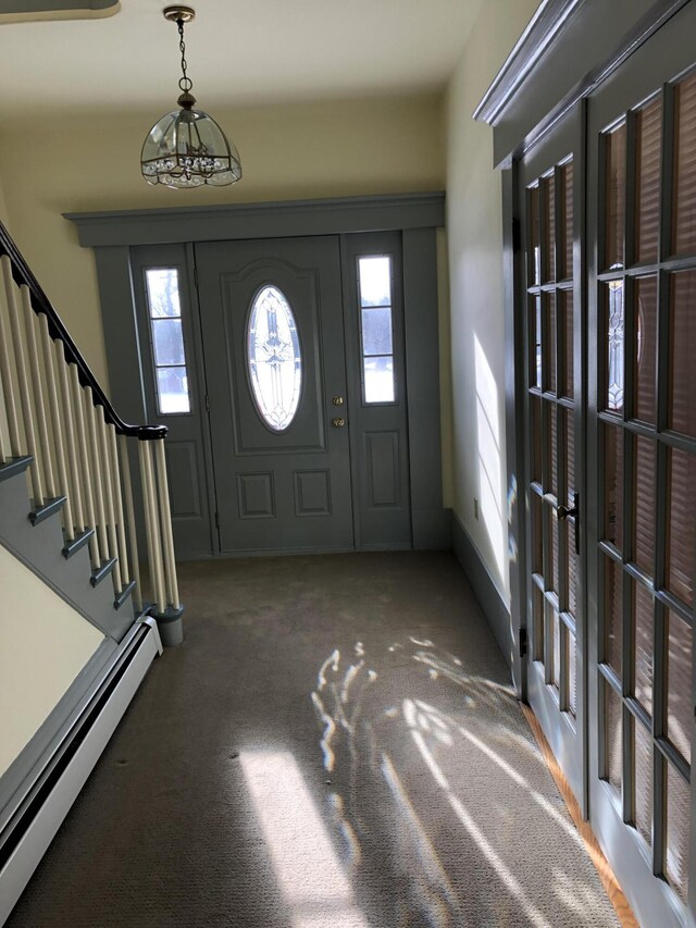 carpeted entrance foyer with baseboard heating