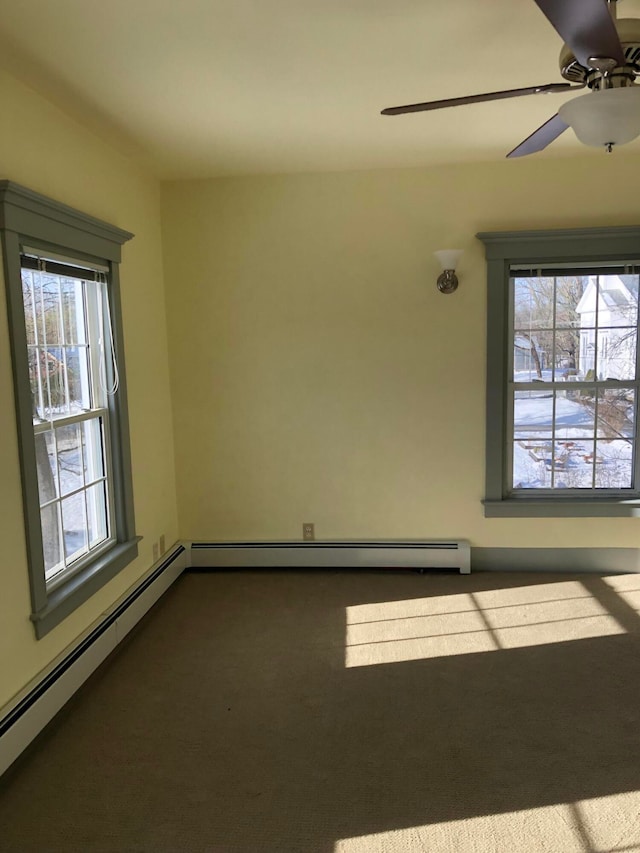 empty room featuring a baseboard radiator, ceiling fan, plenty of natural light, and carpet flooring