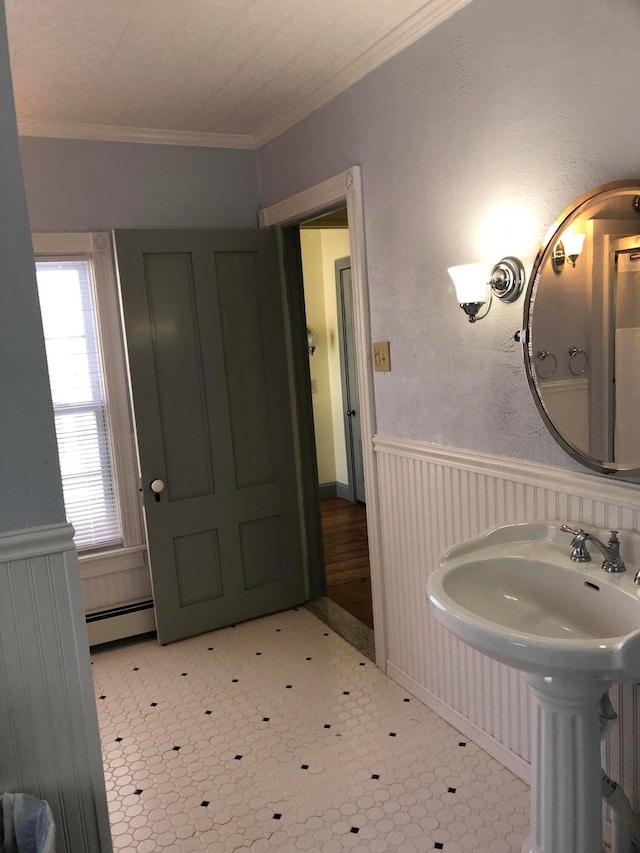 bathroom with baseboard heating, tile patterned floors, and crown molding