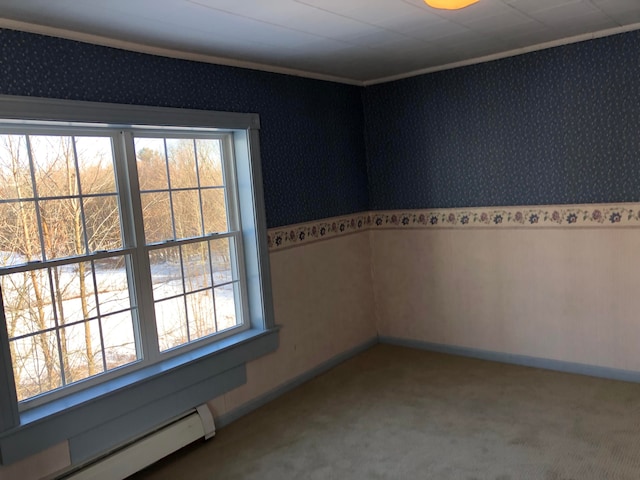 carpeted spare room featuring a healthy amount of sunlight and a baseboard radiator