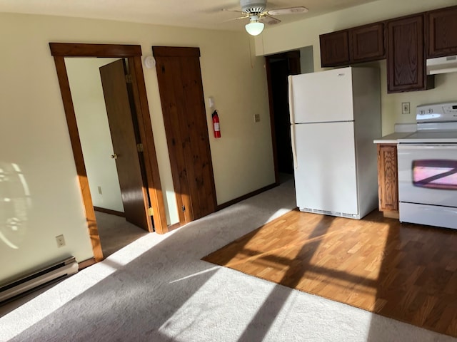 kitchen featuring ceiling fan, dark brown cabinetry, white appliances, a baseboard heating unit, and hardwood / wood-style flooring