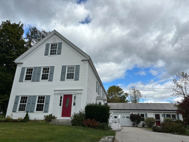 view of front facade with a front yard and a garage