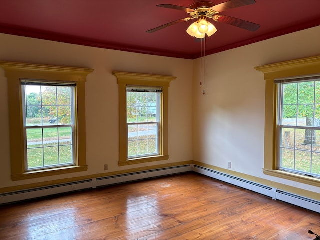 empty room featuring light hardwood / wood-style floors, ceiling fan, and a wealth of natural light