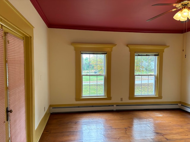 unfurnished room with light wood-type flooring, ornamental molding, baseboard heating, and ceiling fan