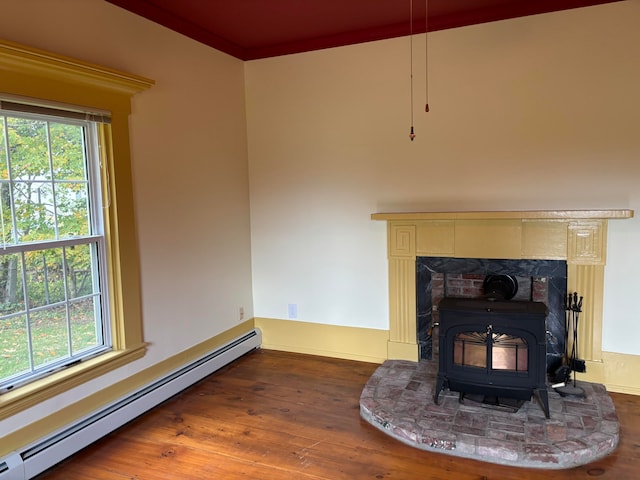 details featuring wood-type flooring, a baseboard radiator, ornamental molding, and a wood stove