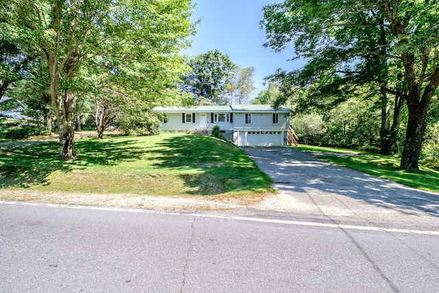 view of front of property featuring a garage and a front lawn