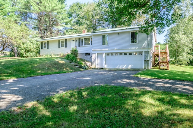 view of front of house featuring a front yard and a garage