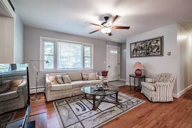 living room with hardwood / wood-style floors, baseboard heating, and ceiling fan