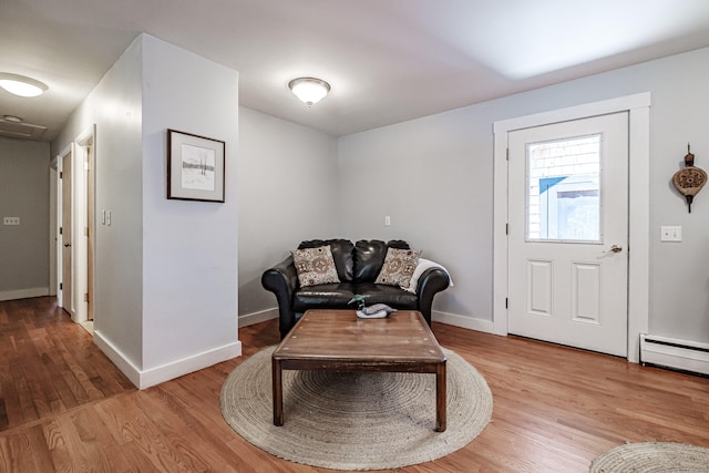 living area featuring wood-type flooring and baseboard heating